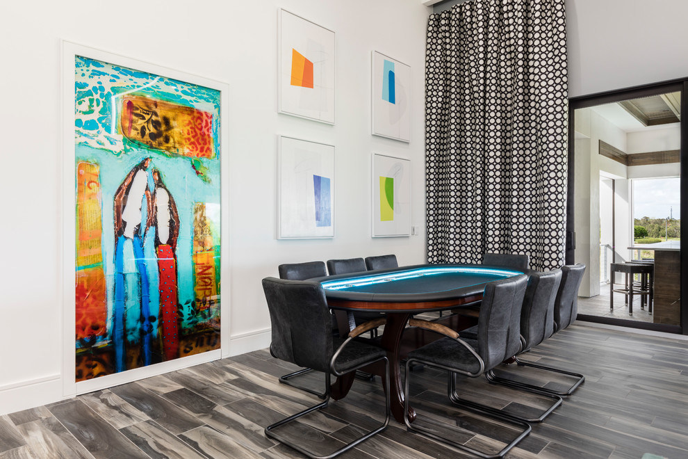 Trendy brown floor game room photo in Orlando with white walls and no fireplace