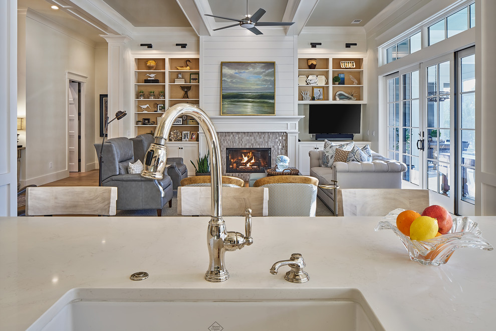 Example of a mid-sized transitional open concept light wood floor family room design in Charleston with white walls, a standard fireplace, a stone fireplace and a tv stand