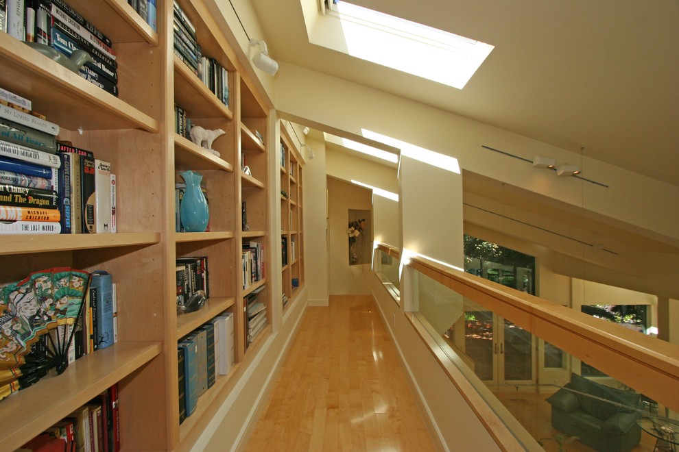 Источник вдохновения для домашнего уюта: двухуровневая гостиная комната в современном стиле с с книжными шкафами и полками и светлым паркетным полом