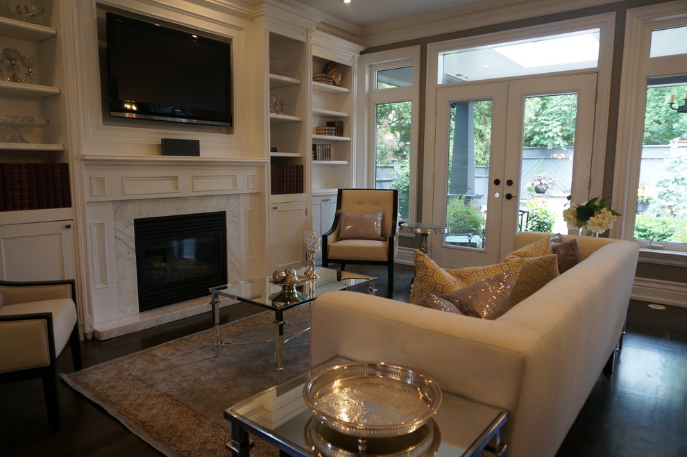 Family room - traditional enclosed dark wood floor family room idea in Toronto with gray walls, a standard fireplace and a wall-mounted tv