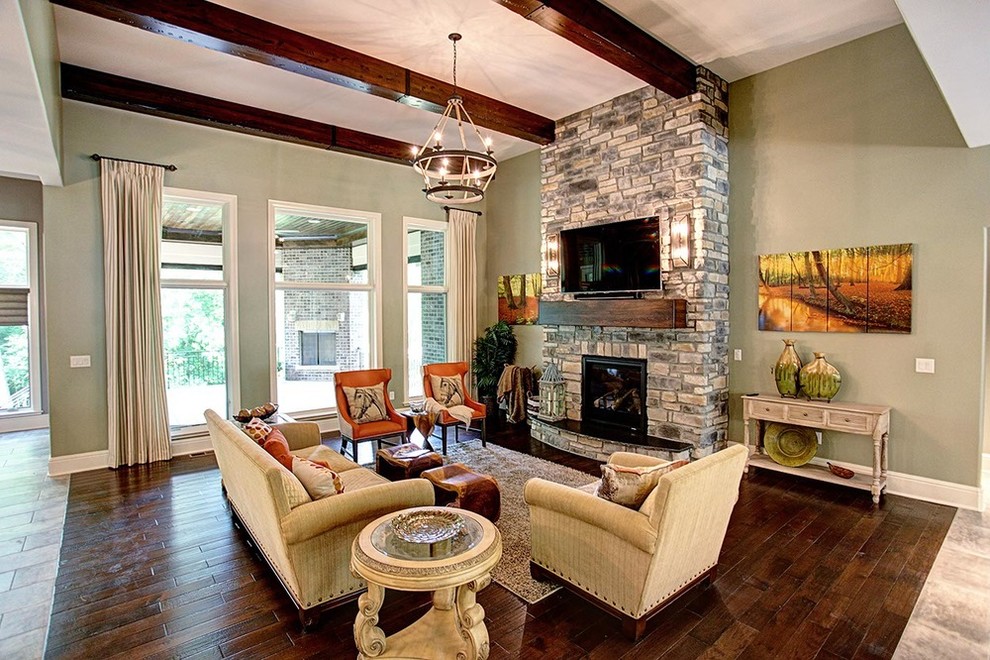 Medium sized rustic enclosed games room in Other with green walls, dark hardwood flooring, a standard fireplace, a stone fireplace surround, a wall mounted tv and brown floors.