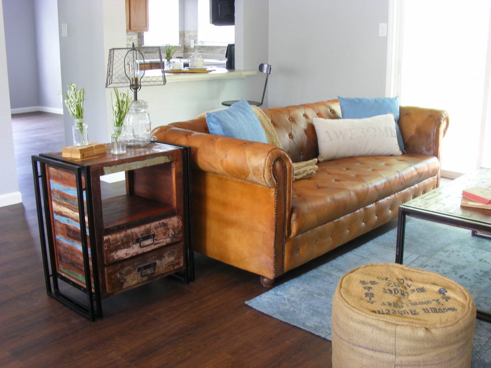 Small industrial open plan games room in Austin with grey walls, a ribbon fireplace and dark hardwood flooring.