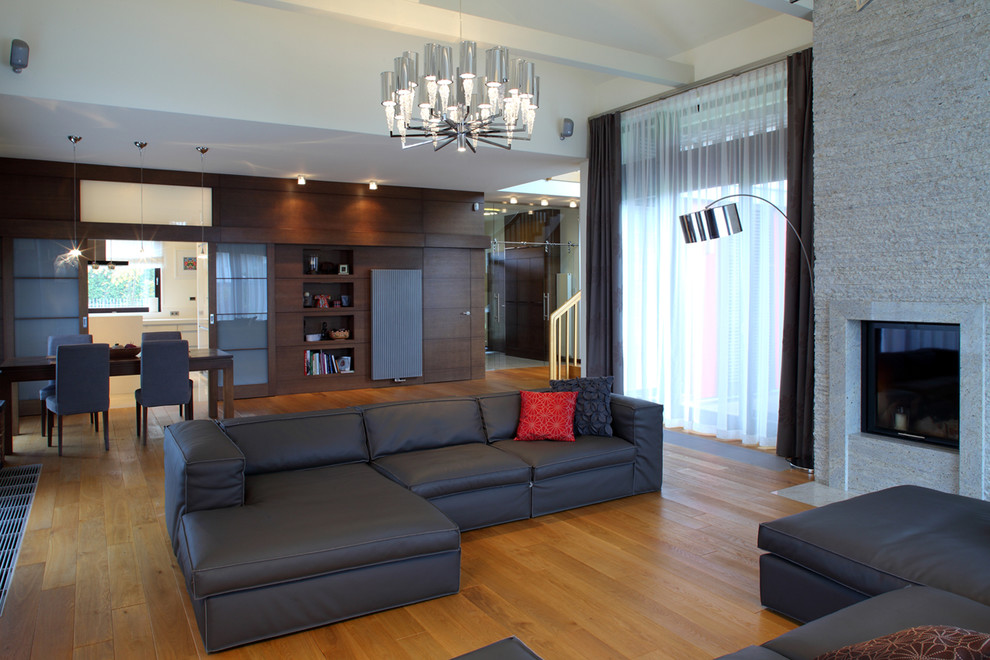 This is an example of a contemporary open plan living room in Other with medium hardwood flooring.
