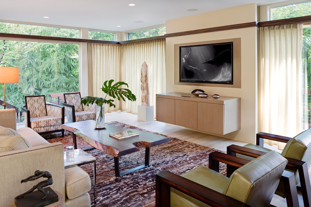 This is an example of a contemporary games room in DC Metro with beige walls and a wall mounted tv.