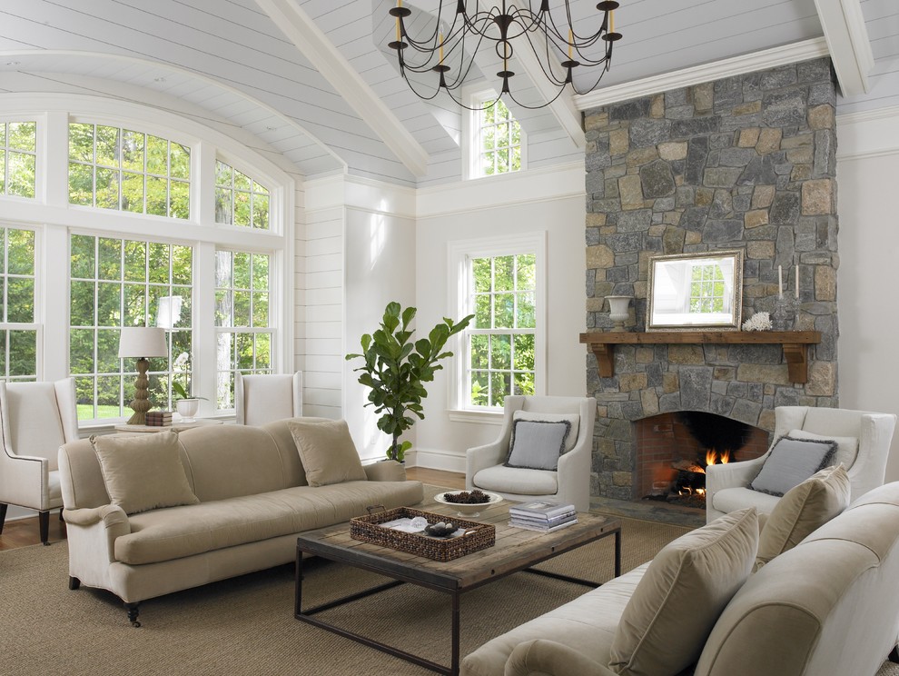 Family room - traditional family room idea in New York with beige walls, a standard fireplace and a stone fireplace