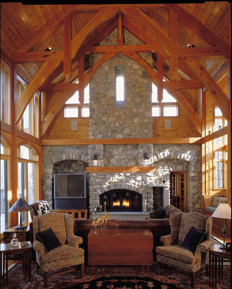 Design ideas for a rustic open plan games room in Baltimore with beige walls, a standard fireplace, a stone fireplace surround and a freestanding tv.