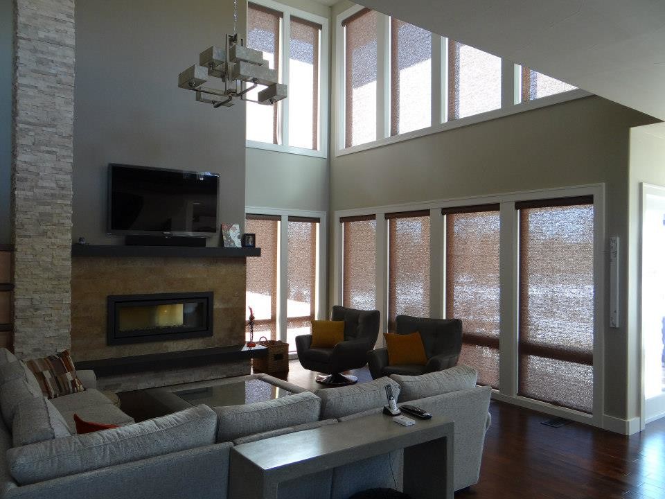 Contemporary open plan games room in Denver with beige walls, dark hardwood flooring, a standard fireplace and a wall mounted tv.