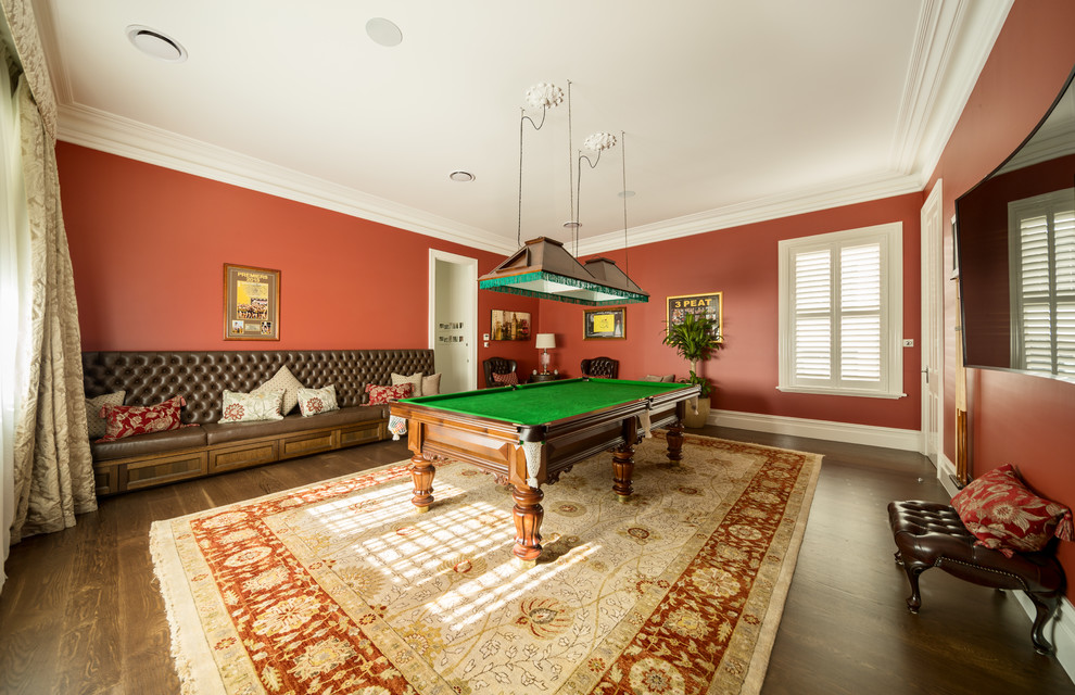 Photo of a classic enclosed games room in Melbourne with red walls, dark hardwood flooring, a wall mounted tv and brown floors.