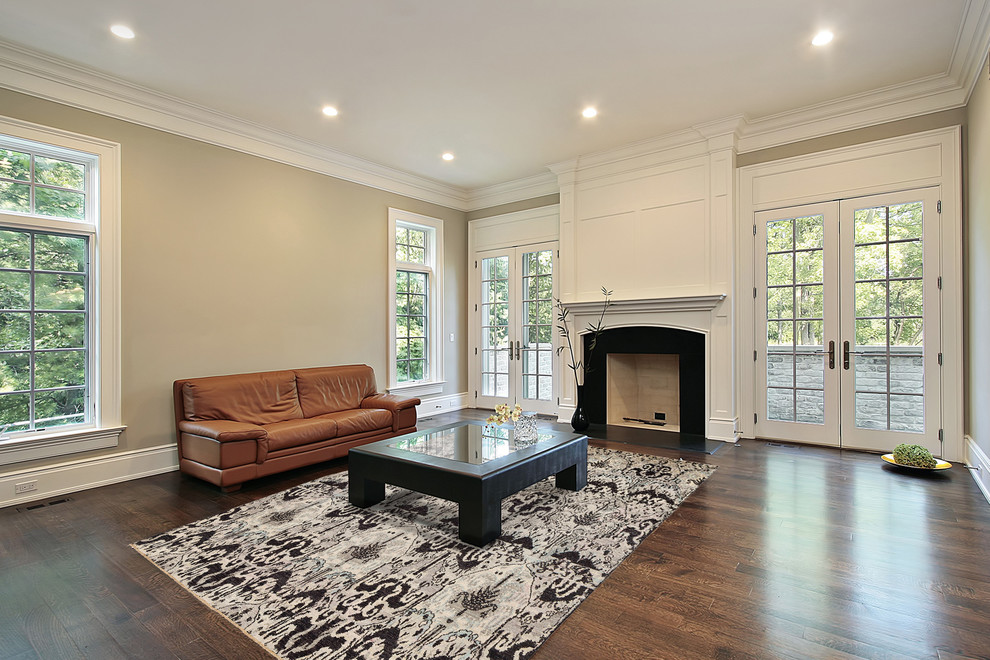 Medium sized contemporary games room in DC Metro with beige walls, dark hardwood flooring, a standard fireplace and a wooden fireplace surround.