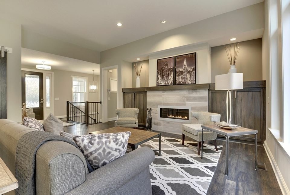 Inspiration for a medium sized traditional open plan games room in Minneapolis with grey walls, dark hardwood flooring, a ribbon fireplace, a tiled fireplace surround and feature lighting.