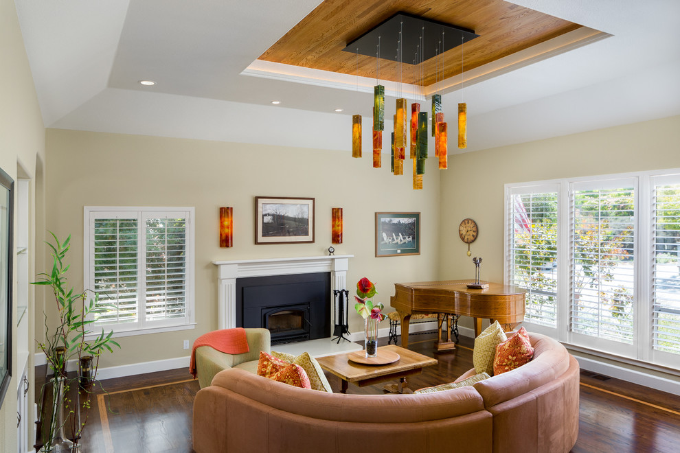 Example of a large transitional enclosed dark wood floor family room design in San Francisco with yellow walls, a standard fireplace and a concrete fireplace