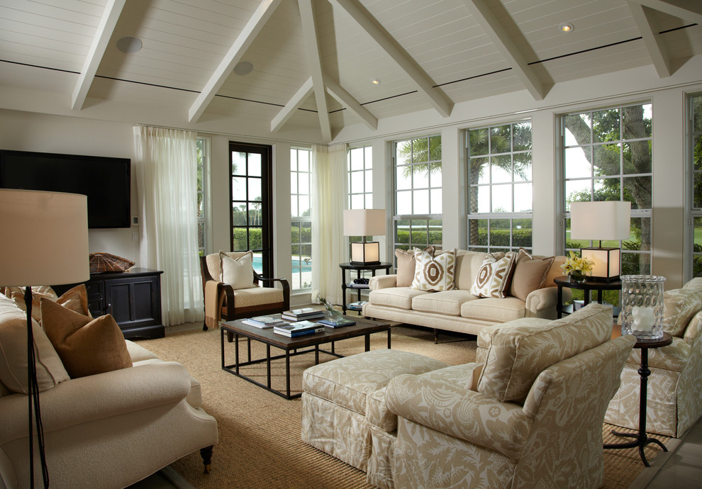 Example of a large classic light wood floor family room design in Miami with white walls and a wall-mounted tv