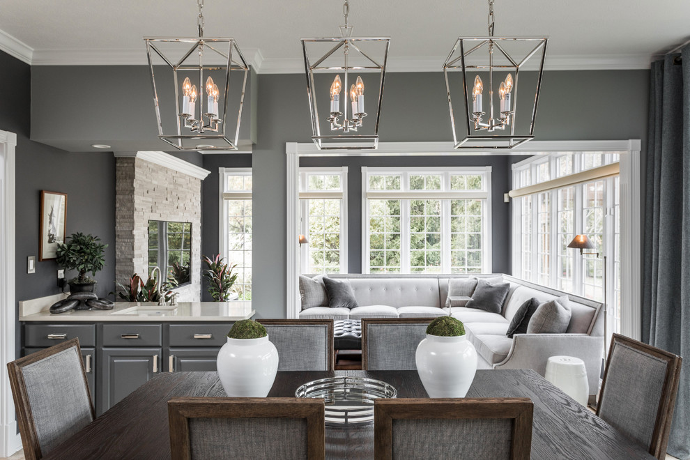 Mid-sized transitional enclosed travertine floor family room photo in New York with gray walls and a media wall