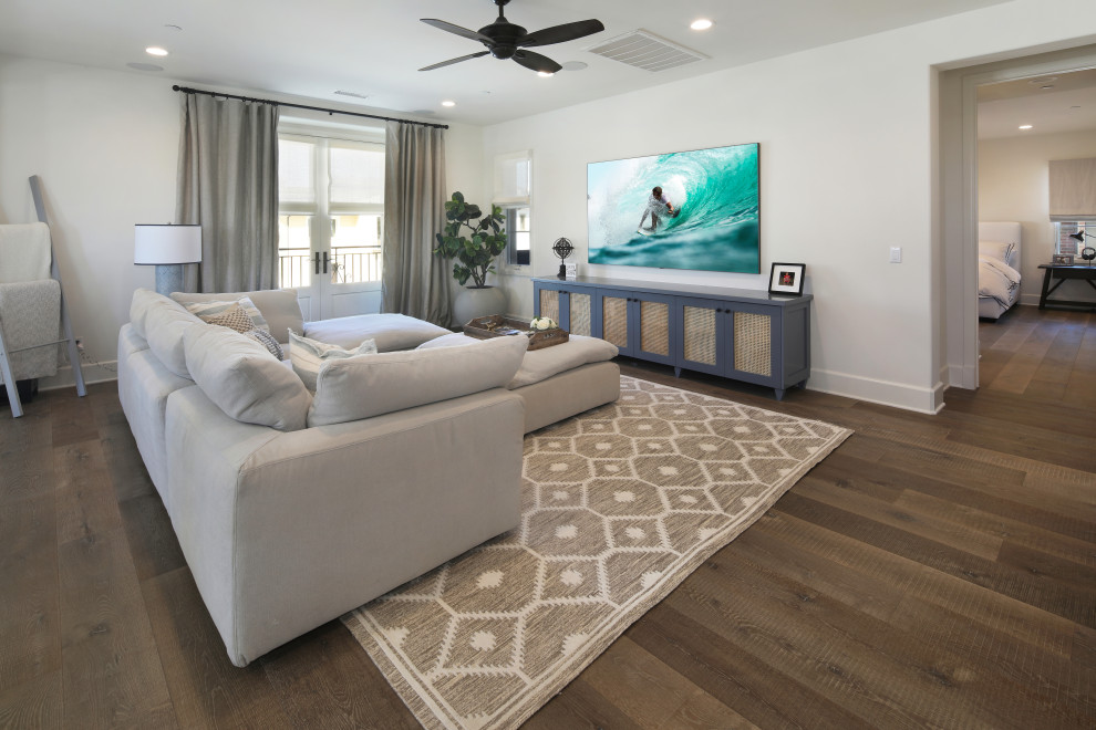 Design ideas for a large beach style games room in Orange County with white walls, medium hardwood flooring and a wall mounted tv.