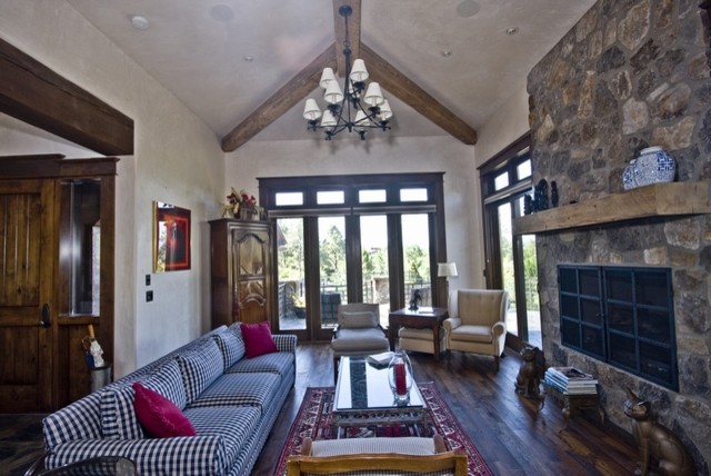 Photo of an expansive classic enclosed games room in Phoenix with a reading nook, beige walls, travertine flooring, a standard fireplace, a stone fireplace surround and no tv.