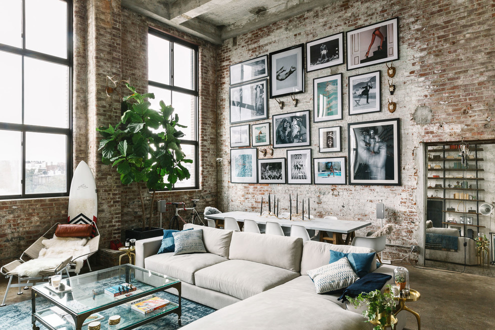 Inspiration for an industrial open concept concrete floor and gray floor family room remodel in Other with red walls and a wall-mounted tv