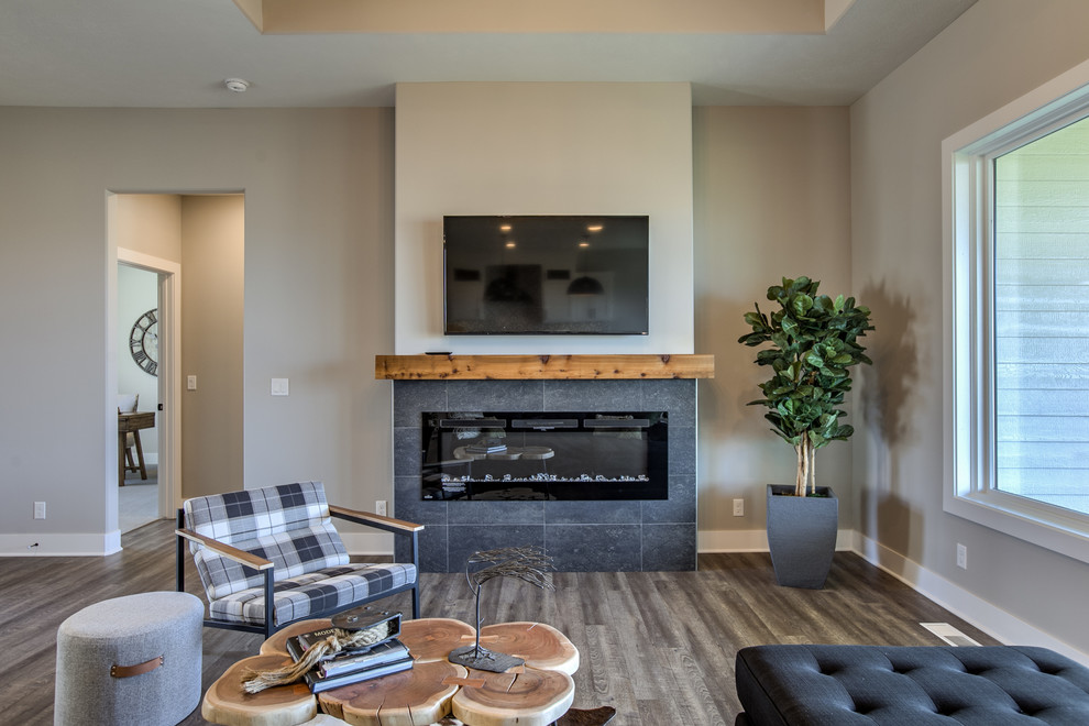 На фото: открытая гостиная комната в стиле лофт с горизонтальным камином, фасадом камина из плитки и телевизором на стене