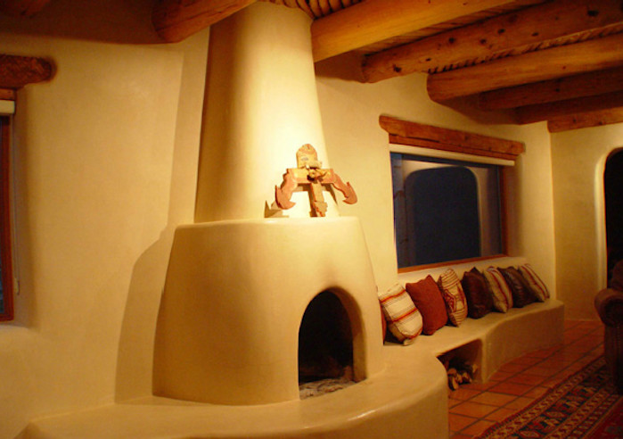 Пример оригинального дизайна: изолированная гостиная комната среднего размера в стиле фьюжн с бежевыми стенами, полом из терракотовой плитки, стандартным камином, фасадом камина из штукатурки и красным полом без телевизора