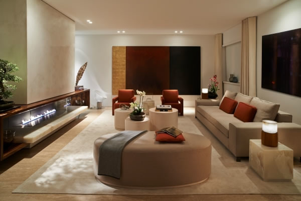 Photo of a large modern open plan games room in Other with a reading nook, white walls, plywood flooring, a standard fireplace, a tiled fireplace surround, a wall mounted tv and brown floors.