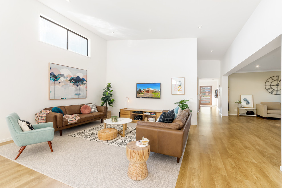 Inspiration for a mid-sized contemporary open concept medium tone wood floor and brown floor family room remodel in Geelong with white walls