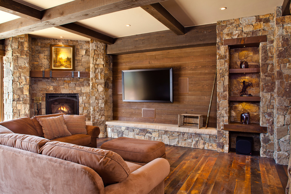 Family room - mid-sized rustic open concept dark wood floor and brown floor family room idea in Denver with a corner fireplace, a stone fireplace, brown walls and a wall-mounted tv