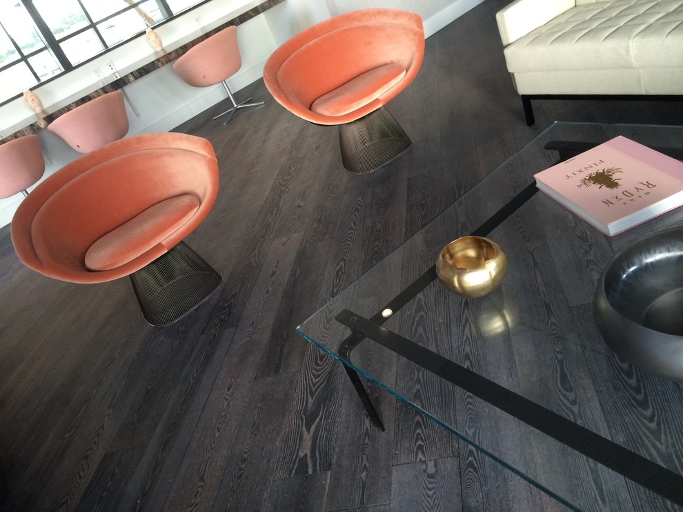 This is an example of a modern games room in Miami with dark hardwood flooring.