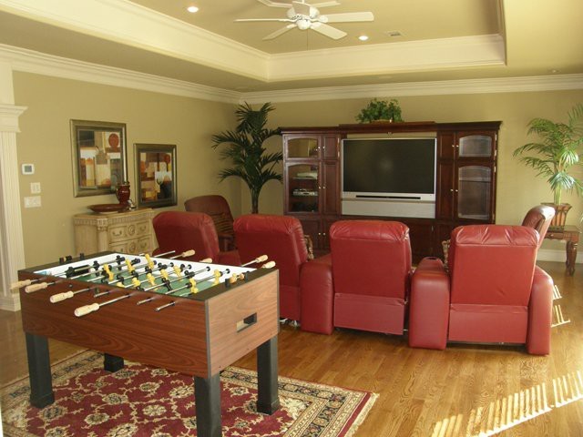 Inspiration for a medium sized traditional games room in Little Rock with beige walls, light hardwood flooring, no fireplace and a built-in media unit.