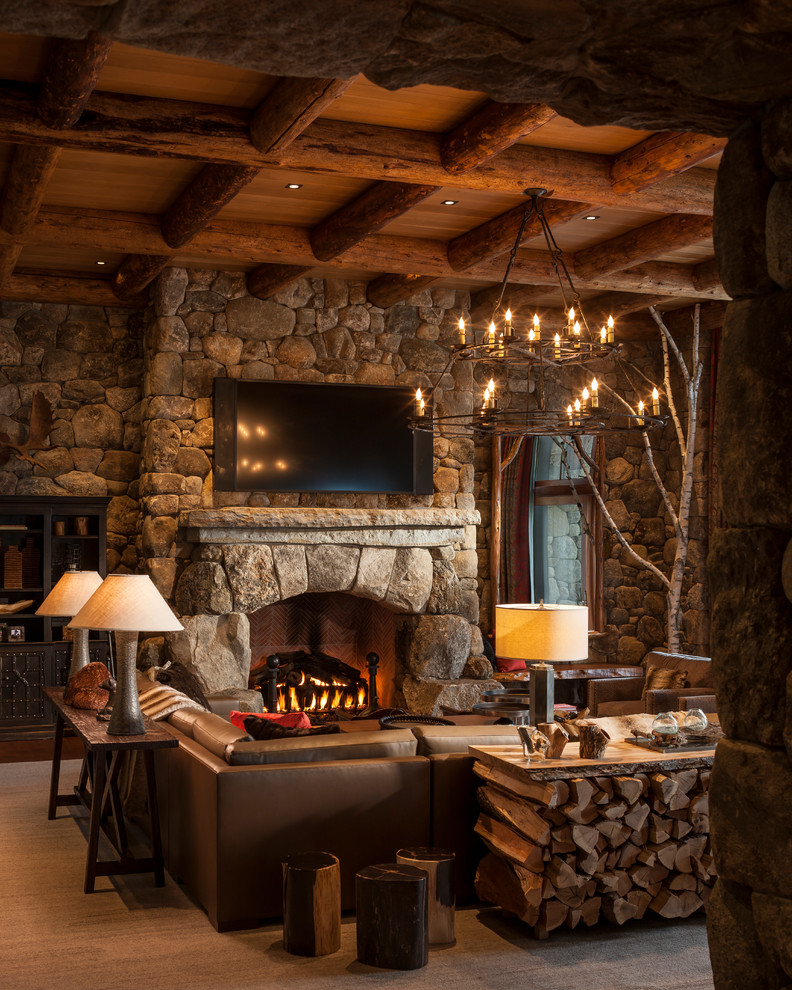 Photo of a rustic games room in New York with multi-coloured walls, a standard fireplace, a stone fireplace surround and a wall mounted tv.