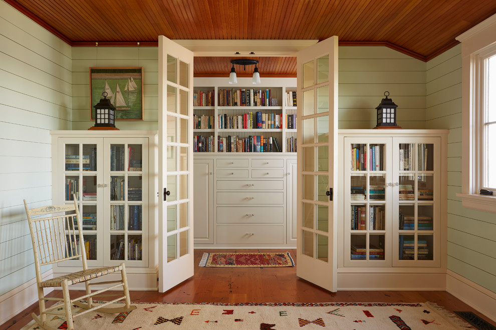 Inspiration for a coastal medium tone wood floor family room library remodel in Minneapolis with green walls, no fireplace and no tv