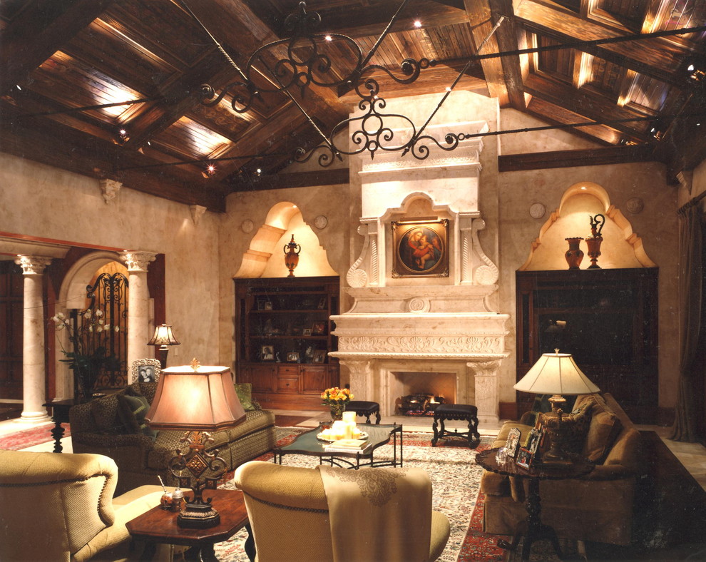 Inspiration for a large mediterranean enclosed games room in Orlando with beige walls, travertine flooring, a standard fireplace, a stone fireplace surround and a built-in media unit.