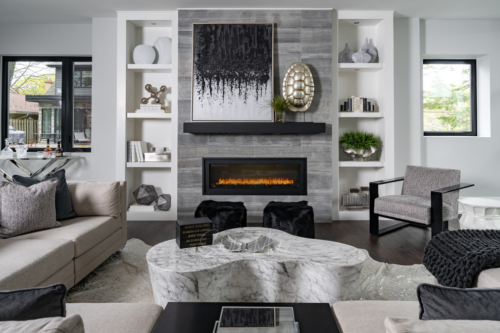 This is an example of a large modern open plan games room in Toronto with grey walls, medium hardwood flooring, a stone fireplace surround, brown floors and a ribbon fireplace.