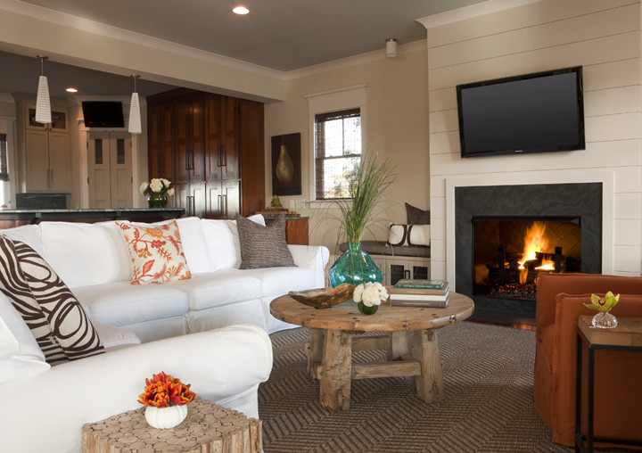 Mid-sized beach style open concept carpeted family room photo in Charleston with beige walls, a standard fireplace, a stone fireplace and a wall-mounted tv