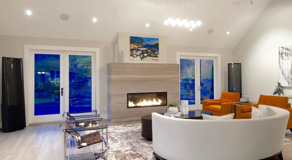 This is an example of a medium sized contemporary enclosed games room in New York with grey walls, porcelain flooring, a standard fireplace, a stone fireplace surround and no tv.