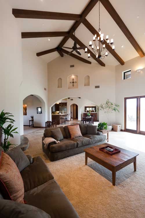Mid-sized tuscan open concept carpeted family room photo in San Luis Obispo with beige walls and no fireplace