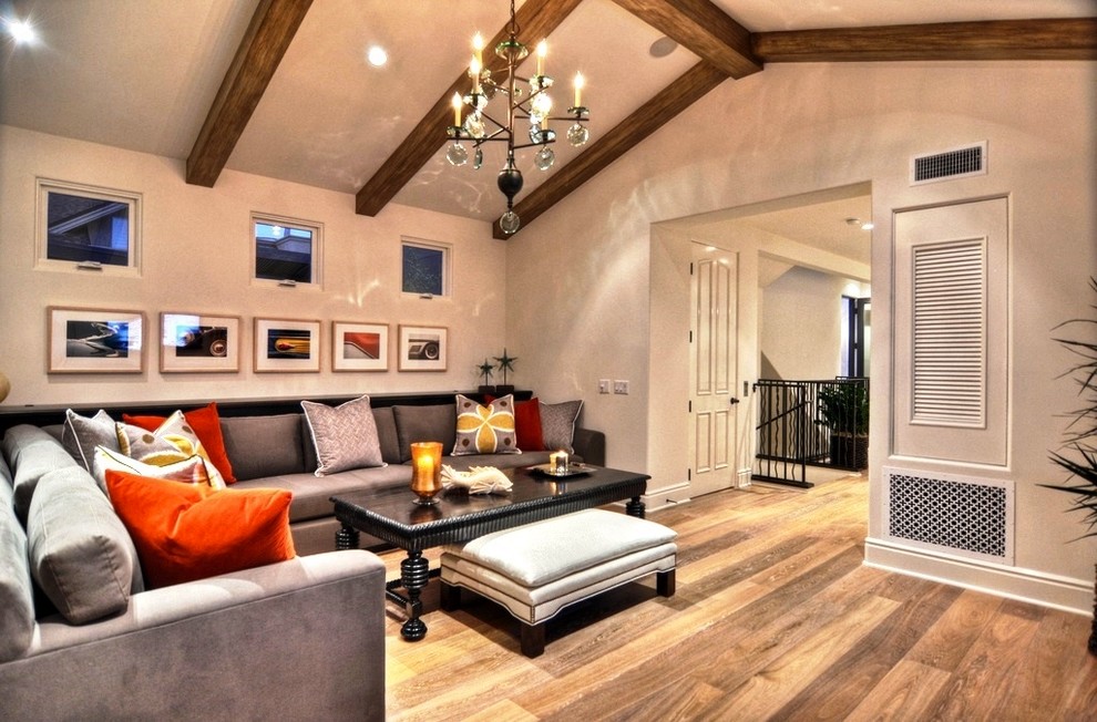 Large trendy enclosed medium tone wood floor family room photo in Orange County with white walls and no fireplace