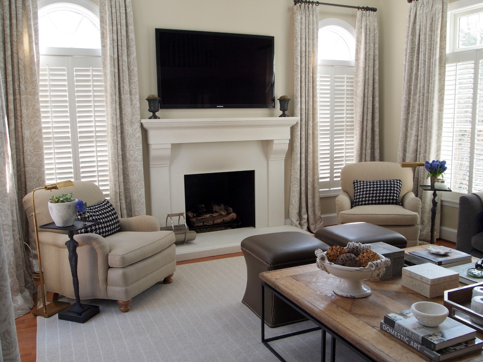 Example of a classic living room design in Baltimore with beige walls, a standard fireplace and a wall-mounted tv