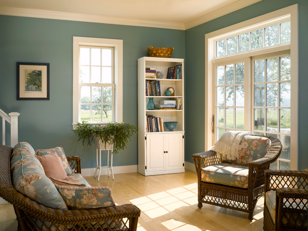 This is an example of a farmhouse games room in Burlington with light hardwood flooring and blue walls.