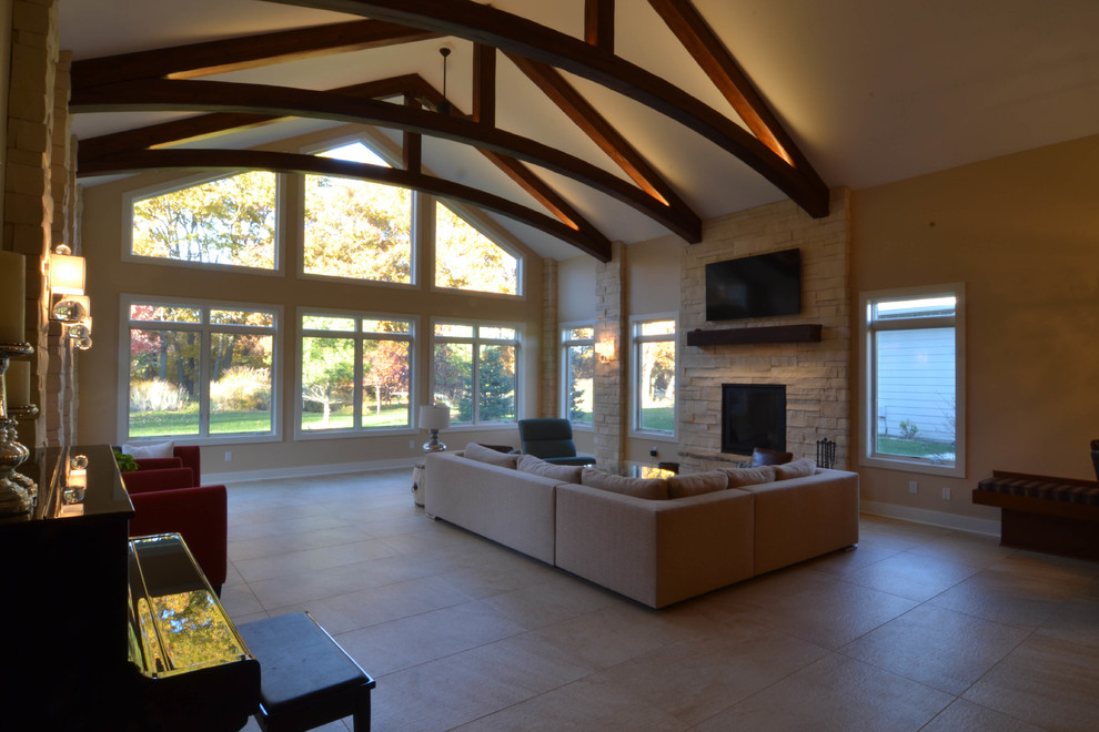 Cette photo montre une grande salle de séjour tendance ouverte avec un mur beige, parquet clair, une cheminée standard, un manteau de cheminée en brique et un sol jaune.