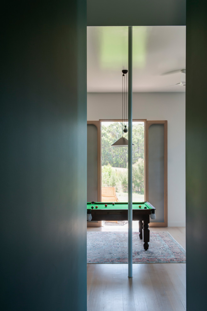 Photo of a large modern enclosed games room in Other with a game room, green walls, painted wood flooring, white floors, no fireplace and no tv.