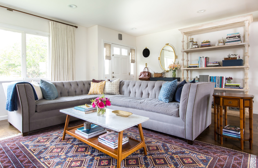Bohemian living room in Los Angeles with white walls, dark hardwood flooring and brown floors.