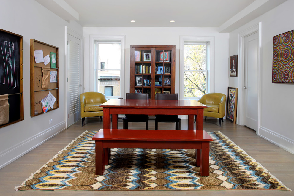 Family room - transitional enclosed medium tone wood floor family room idea in Chicago with white walls and no fireplace