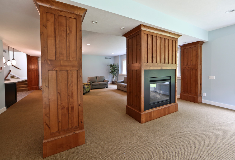 Inspiration for a large timeless open concept carpeted family room remodel in Grand Rapids with blue walls, a two-sided fireplace and a wood fireplace surround