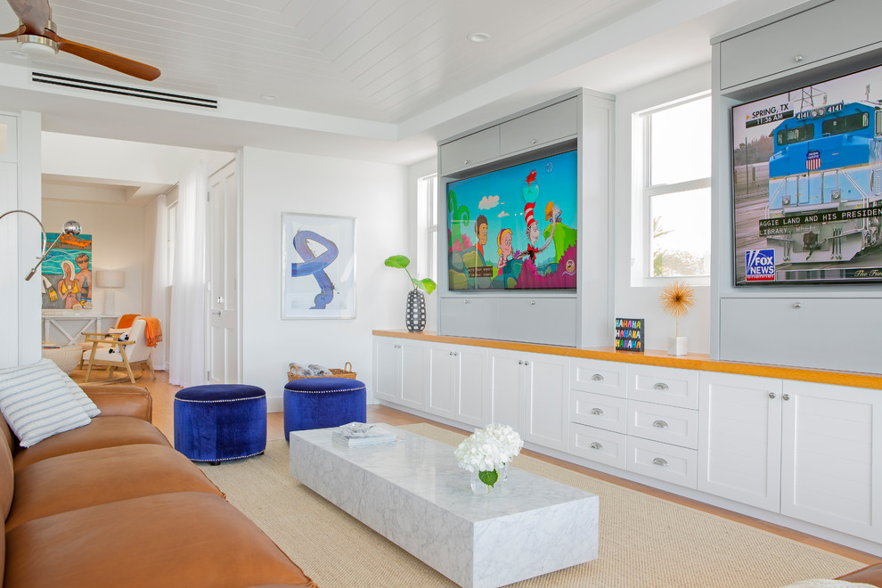 Immagine di un soggiorno stile marinaro di medie dimensioni e aperto con pareti grigie, parquet chiaro, parete attrezzata e pavimento beige