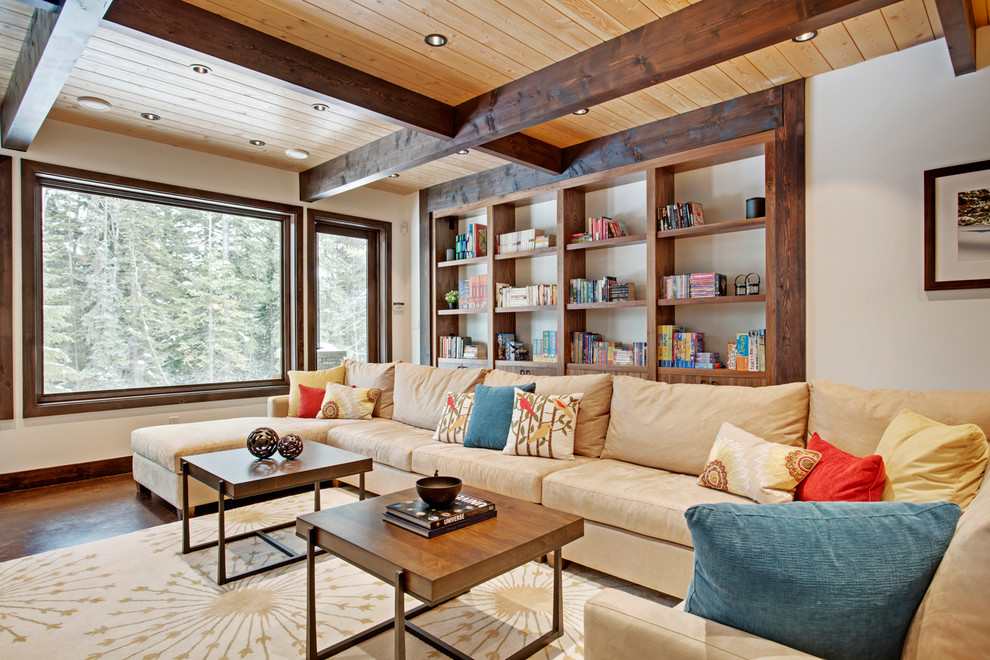 Example of a huge mountain style open concept concrete floor family room design in Vancouver with white walls and a wall-mounted tv