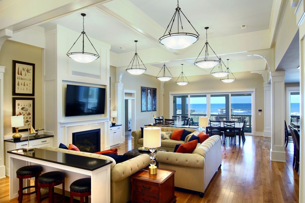 Inspiration for a medium sized beach style open plan games room in Other with beige walls, medium hardwood flooring, a standard fireplace, a tiled fireplace surround and a wall mounted tv.