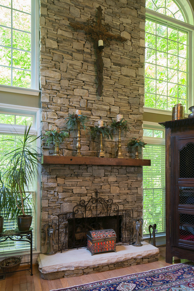 Photo of a contemporary open plan games room in Atlanta with a standard fireplace and a stone fireplace surround.