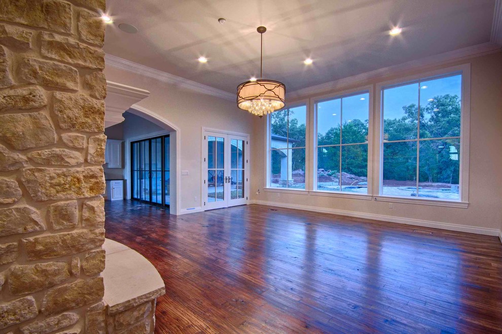 This is an example of a medium sized classic games room in San Diego with light hardwood flooring and a stone fireplace surround.