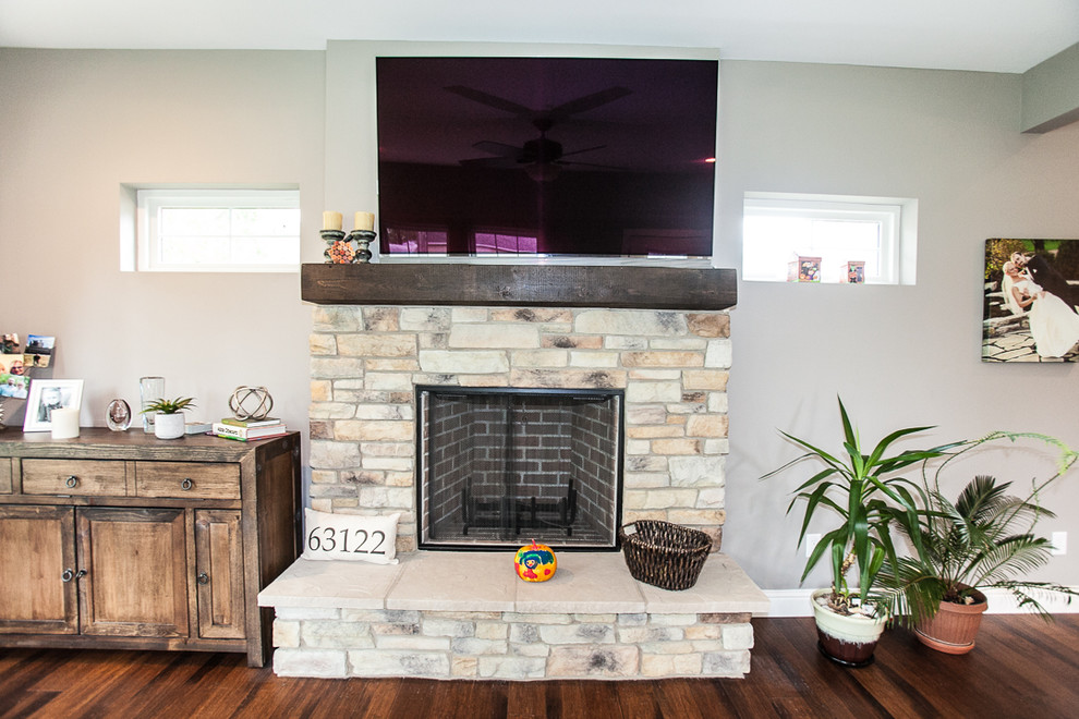 Traditional games room in St Louis with a standard fireplace and a stone fireplace surround.