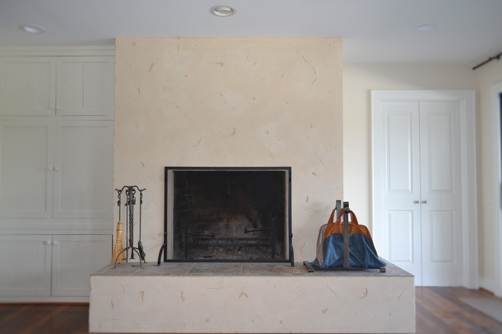 リッチモンドにあるサンタフェスタイルのおしゃれなファミリールーム (ベージュの壁、無垢フローリング、標準型暖炉、コンクリートの暖炉まわり) の写真