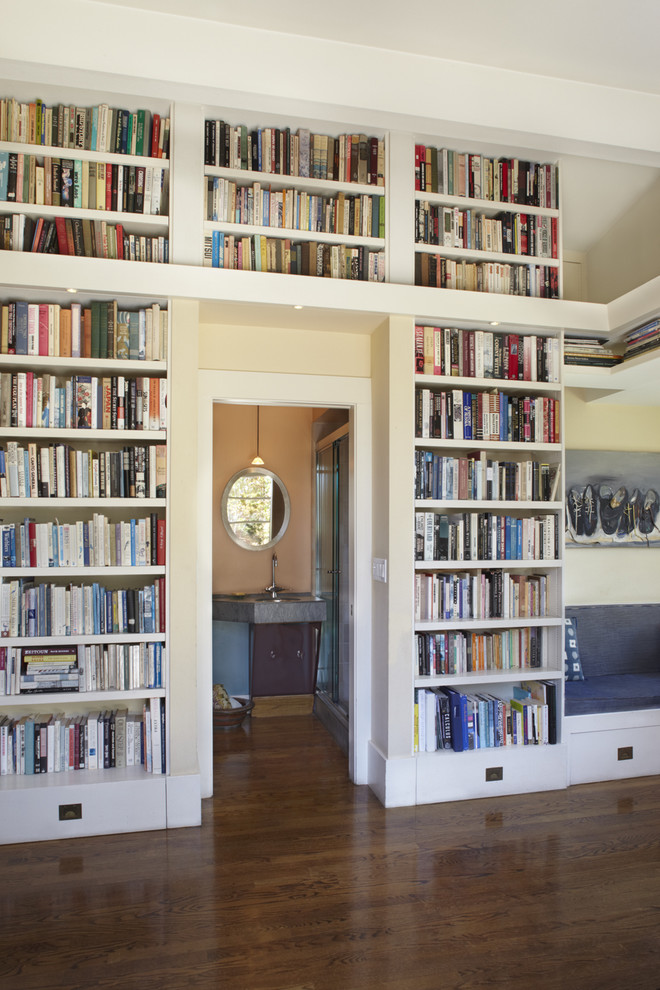 Mid-sized trendy dark wood floor and brown floor family room library photo in San Francisco with white walls